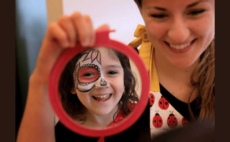 girl with Dia de los Muertos face paint