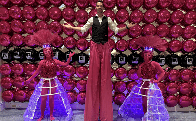 Pink stilt and strolling character at the Ritz